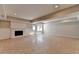 Spacious finished basement featuring tile floors, a fireplace, and access to the backyard at 5567 Stapleton Dr, Dunwoody, GA 30338