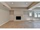 Basement features a fireplace with a black firebox and white brick surround at 5567 Stapleton Dr, Dunwoody, GA 30338
