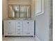 A bright bathroom with a double vanity, white cabinets and granite counters at 5567 Stapleton Dr, Dunwoody, GA 30338