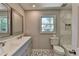 Bright bathroom featuring double vanity, patterned tile floor, and marble accents at 5567 Stapleton Dr, Dunwoody, GA 30338