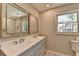 Bathroom featuring a double vanity, large mirrors, and a window for natural lighting at 5567 Stapleton Dr, Dunwoody, GA 30338