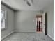 Empty bedroom featuring neutral-colored walls, carpeted floors, a ceiling fan, and bright, natural light at 5567 Stapleton Dr, Dunwoody, GA 30338