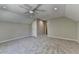 Carpeted bedroom with a ceiling fan, natural light from a window, and access to other rooms at 5567 Stapleton Dr, Dunwoody, GA 30338