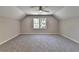 Spacious bedroom with neutral carpet, fan, and large window at 5567 Stapleton Dr, Dunwoody, GA 30338