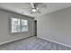 A serene bedroom with a ceiling fan, window, and neutral paint at 5567 Stapleton Dr, Dunwoody, GA 30338