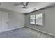 Bright bedroom with a large window, plush carpet, and modern ceiling fan at 5567 Stapleton Dr, Dunwoody, GA 30338