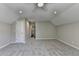 Spacious carpeted bedroom with ceiling fan, neutral walls, and a hallway leading to more rooms at 5567 Stapleton Dr, Dunwoody, GA 30338