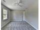 A clean and spacious bedroom with plush carpet, large window, and ceiling fan at 5567 Stapleton Dr, Dunwoody, GA 30338
