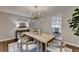 Dining room with modern light fixture, and doorway to the bright kitchen at 5567 Stapleton Dr, Dunwoody, GA 30338