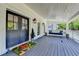 Charming covered porch with porch swing and double front doors at 5567 Stapleton Dr, Dunwoody, GA 30338