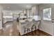 Bright kitchen with white cabinets, breakfast bar seating, and hardwood floors extending to the doorway at 5567 Stapleton Dr, Dunwoody, GA 30338