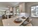 Eat-in kitchen with white cabinets, quartz counters, stainless appliances, and barstool seating at 5567 Stapleton Dr, Dunwoody, GA 30338