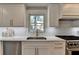 Modern kitchen featuring stainless steel appliances, white cabinets, and quartz countertop at 5567 Stapleton Dr, Dunwoody, GA 30338