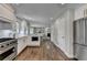 Modern kitchen features stainless appliances, white cabinets, and open floor plan at 5567 Stapleton Dr, Dunwoody, GA 30338