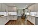 Bright kitchen with white cabinets, stainless appliances and hardwood flooring at 5567 Stapleton Dr, Dunwoody, GA 30338