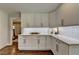 Bright kitchen features white cabinets, gold hardware, subway tile backsplash, and quartz countertops at 5567 Stapleton Dr, Dunwoody, GA 30338