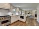 Modern kitchen features stainless steel appliances, white cabinets, and an open layout to the living area at 5567 Stapleton Dr, Dunwoody, GA 30338