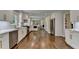Open concept kitchen with stainless appliances, white cabinets, and hardwood floors at 5567 Stapleton Dr, Dunwoody, GA 30338