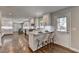 Spacious kitchen with white cabinetry, a breakfast bar, stainless steel appliances, and hardwood floors at 5567 Stapleton Dr, Dunwoody, GA 30338