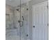 Marble tiled shower with rainfall shower head and built-in seat at 5567 Stapleton Dr, Dunwoody, GA 30338
