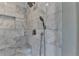 Marble tiled shower featuring rainfall shower head and built-in niche at 5567 Stapleton Dr, Dunwoody, GA 30338