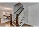 Elegant staircase with wooden steps and white railings leads to the upper level at 5567 Stapleton Dr, Dunwoody, GA 30338