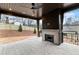 An elegant brick back porch with fireplace and ceiling fan offers outdoor relaxation at 56 Pine St, Roswell, GA 30075