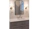 Bathroom vanity with stone countertop, undermount sink, and sconces at 56 Pine St, Roswell, GA 30075