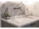 Close-up of bathroom sink with granite countertops, modern faucet, and geometric decor at 56 Pine St, Roswell, GA 30075