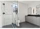 Contemporary bathroom with glass shower, hexagon tile floor and double vanity with modern fixtures at 56 Pine St, Roswell, GA 30075