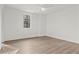 Bright bedroom with hardwood floors, a ceiling fan, and a view of a window at 56 Pine St, Roswell, GA 30075