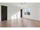 Bedroom featuring hardwood flooring, large windows, and a modern ceiling fan at 56 Pine St, Roswell, GA 30075