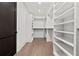 A large walk-in closet boasts custom shelving for ample storage and organization at 56 Pine St, Roswell, GA 30075