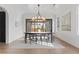 Elegant dining room with hardwood floors, modern chandelier, and view of backyard at 56 Pine St, Roswell, GA 30075