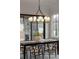 Dining room with views of outdoor fireplace, modern table and chairs, and modern light fixture at 56 Pine St, Roswell, GA 30075