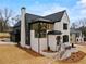 Stunning two-story home with brick exterior, modern design, and meticulously landscaped front yard at 56 Pine St, Roswell, GA 30075