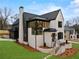 Beautiful two-story home with a brick exterior, black trim, and manicured landscaping at 56 Pine St, Roswell, GA 30075