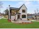 Stunning two-story home with modern design, brick facade, black framed windows, and professional landscaping at 56 Pine St, Roswell, GA 30075