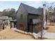 A dark siding house features a well-maintained yard and a three-car garage at 56 Pine St, Roswell, GA 30075