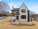 Elegant exterior with brick, dark shutters, and lush green lawn at 56 Pine St, Roswell, GA 30075