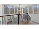 Bright hallway featuring large windows, hardwood floors, and a modern chandelier at 56 Pine St, Roswell, GA 30075