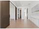 Spacious hallway with sliding barn doors and hardwood floors throughout at 56 Pine St, Roswell, GA 30075