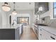 Bright open-concept kitchen with marble countertops, stainless appliances, and view to dining area at 56 Pine St, Roswell, GA 30075