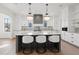 Bright kitchen with white cabinetry, marble countertops, and an island with seating at 56 Pine St, Roswell, GA 30075