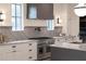 Beautiful kitchen featuring stainless steel appliances, marble countertops and backsplash, and custom cabinets at 56 Pine St, Roswell, GA 30075