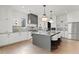 Spacious white kitchen with a gray island, stainless steel appliances, and hardwood floors at 56 Pine St, Roswell, GA 30075