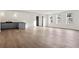 Spacious living area with hardwood floors, a modern bar, and large windows filling the space with light at 56 Pine St, Roswell, GA 30075