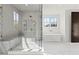 Bright main bathroom with a glass shower, soaking tub, and classic tile floors at 56 Pine St, Roswell, GA 30075