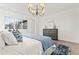 Stylish main bedroom featuring a modern chandelier, hardwood floors, and plenty of natural light at 56 Pine St, Roswell, GA 30075