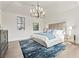 Luxurious main bedroom with a tray ceiling, hardwood floors, and a decorative rug at 56 Pine St, Roswell, GA 30075